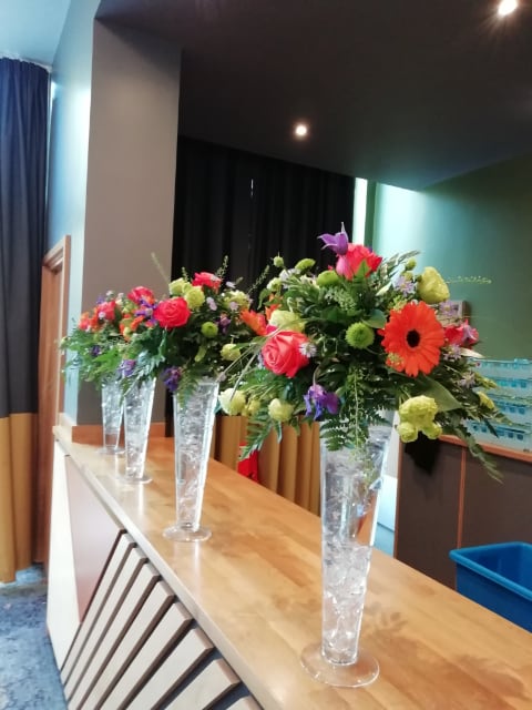 four displays of mixed wedding flowers in vase